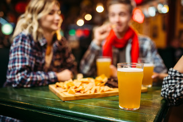 Light beer in glasses on the table in sports bar