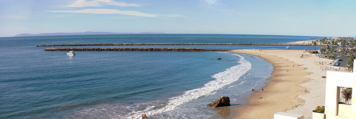 Panorama of Southern California coastline.  View of the marina coastal access to the harbor from a rocky cliff. Corona Del Mar, Newport Beach, California