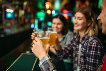 Fans drinks beer at the counter in sports bar