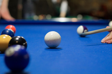 Eight-ball pool game player aims to shoot balls with cue