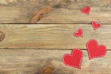 Red paper hearts on a wooden background. Valentine's Day. Copy space. Top view.