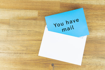 Envelope with a blue note with the words for you have mail