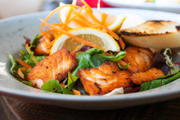 grilled salmon and lemon - french cuisine dish with tomato and salmon