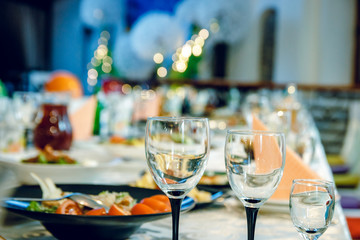 Three glasses on the festive table with food.