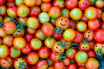 A large number of cherry tomatoes in the form of smiles.