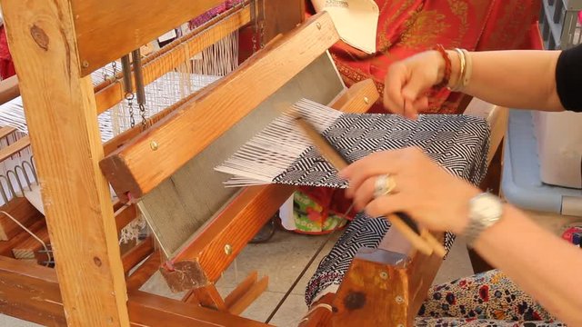 Weaving with a loom. Lleida, Catalonia, Spain.