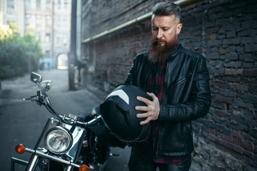 Biker puts on helmet before riding on chopper