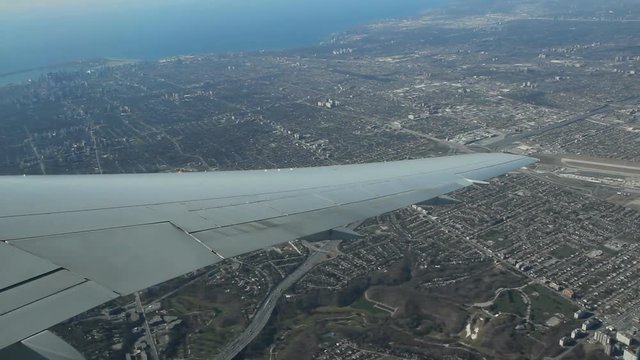 Flying over north Toronto, Ontario, Canada. Highway 401 below. Downsview airport runway at right. Downtown Toronto at top left.