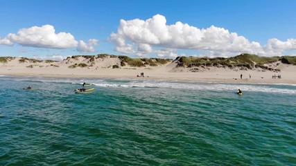 Sliding and point of view of surfers in Northern Sea in Norway on a sunny day