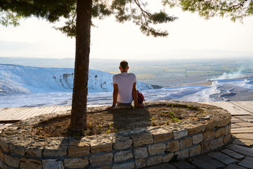 Traveler relaxes under lush pine trees