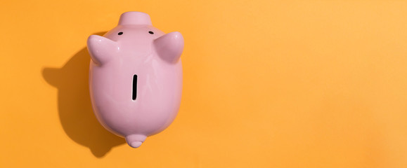 A piggy bank saving and investment theme on a orange background