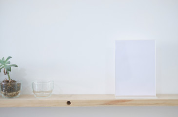 white label on wooden shelf. display stand for acrylic tent card. mockup menu frame.
