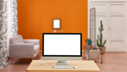 Fototapeta na wymiar Desktop screen and blur orange background, interior.