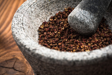 Timut sihuan pepper seeds in granite pestle or mortar