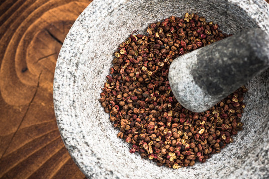 Timut sihuan pepper seeds in granite pestle or mortar