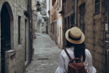 woman walking by tight streets of kotor