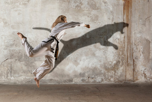 Woman in kimono practicing taekwondo