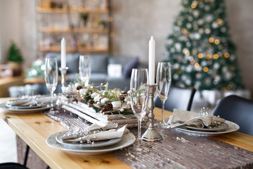 Table setting with holiday decorations. Preparation for christmas dinner
