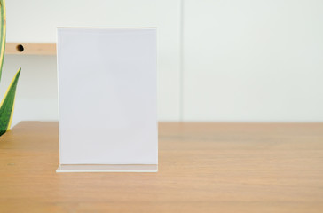 white label in cafe. display stand for acrylic tent card in coffee shop. mockup menu frame on table in restaurant.