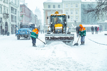 people cleaning city streets after snowstorm