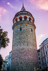 Fototapeta premium Galata Tower at purple night. Historical building or structure in Istanbul, Turkey. Beautiful view of old Galata Tower in twilight. One of the most famous and top rated tourist attraction in Istanbul.