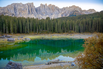 Karersee or Lago di Carezza, is a lake with mountain range of the Latemar group on background in the Dolomites in Tyrol, Italy