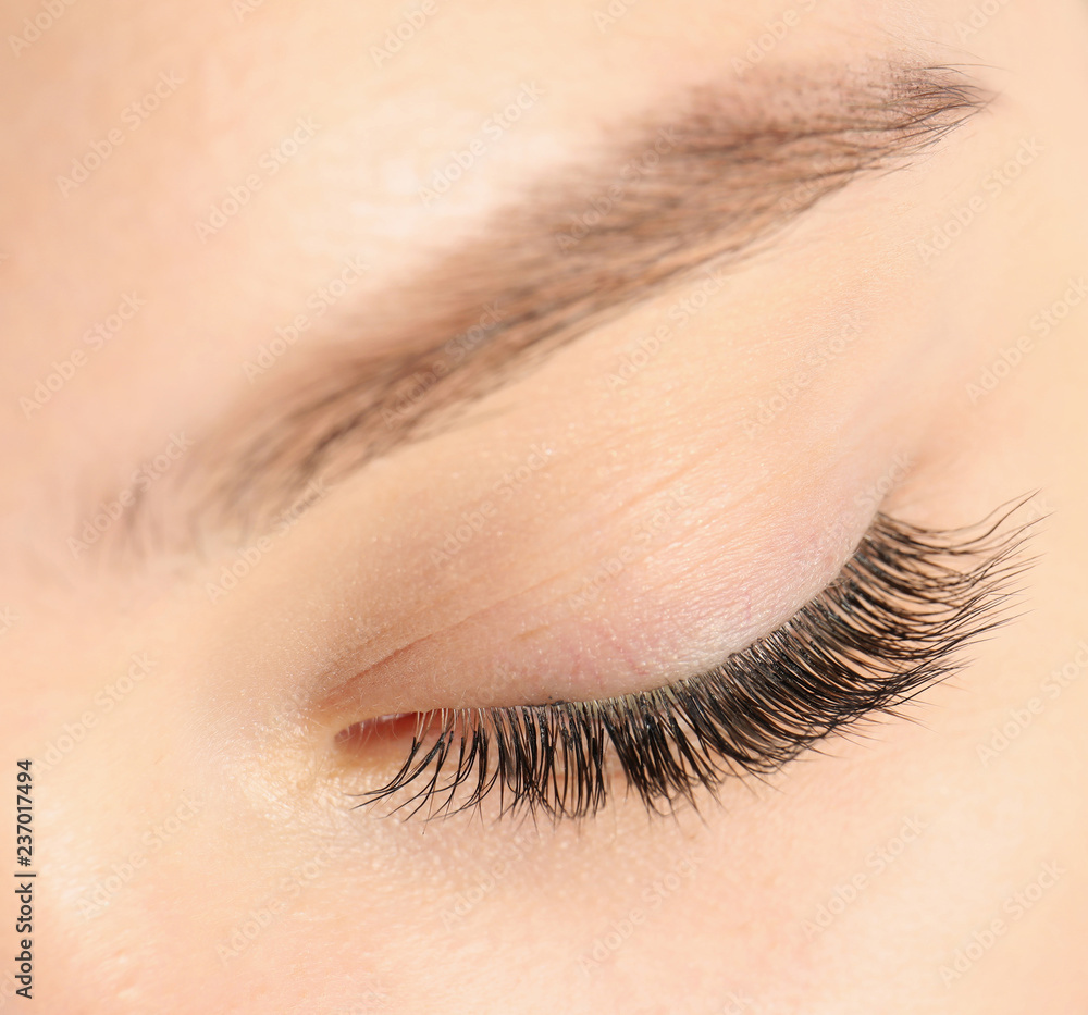 Wall mural Closeup view of beautiful young woman with eyelash extensions