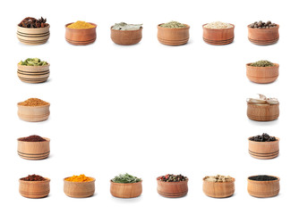 Frame of wooden bowls with different spices and herbs on white background. Large collection with space for design
