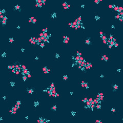It's a seamless floral vector pattern. Blue and pink scattered flowers and branches with blossom print on a navy background. Perfect for textile, scrapbooking, sewing projects.