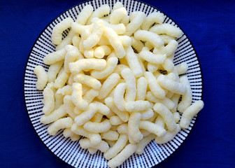 Yellow corn sticks on the plate top view. Corn dishes, healthy desserts, sweet and tasty snack.