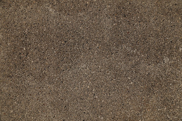 Close-up on a plastered wall. Warm gray and rough wall surface.