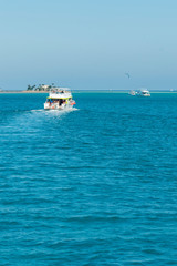 The boat goes on the open sea. aerial view of cruise tourist travel boat going on the sea. vertical photo.