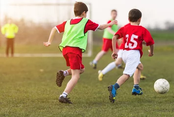 Foto op Plexiglas Young children player on the football match © Dusan Kostic