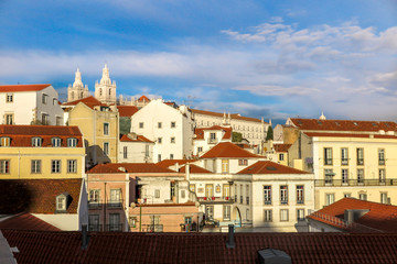 Detail of the architecture of the houses of Lisbon, with the Church of São Vicente de Fora in the background, blue sky with clouds, Portugal