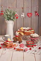 Christmas cake and cookies on table. Christmas  decorations with lights background. Happy New Year! Christmas greeting card. Winter card template. Xmas concept. Holiday Banner. Feast of Nativity. 