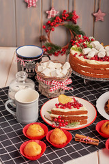Christmas cake and sweets on table. Christmas  decorations with lights background. Happy New Year! Christmas greeting card. Winter card template. Xmas concept. Holiday Banner. Feast of Nativity. 