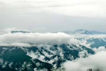 clouds floating over the mountain range, seen from the Zero Point, after a long trek through the forest in Binsar Wildlife Sanctuary, rainy season