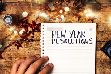 Fototapeta na wymiar Person writing new year resolutions