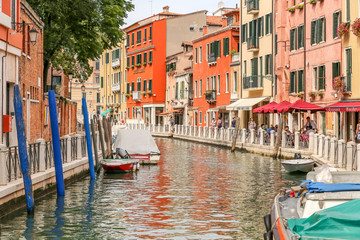 Picturesque canal in Venice with tourists. UNESCO world heritage sites