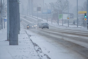Winter, snow, Blizzard, poor visibility on the road. Car during on the road with the headlights.