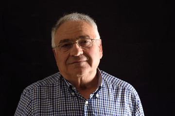 Obraz premium Portrait of a senior man with black background
