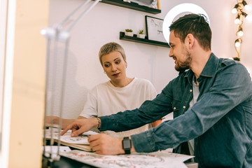 Female tattoo master being surprised by the choice of her client