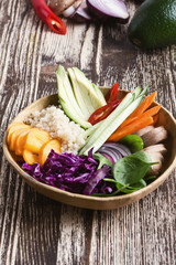 Quinoa veggie bowl with colorful fresh vegetables and fruits