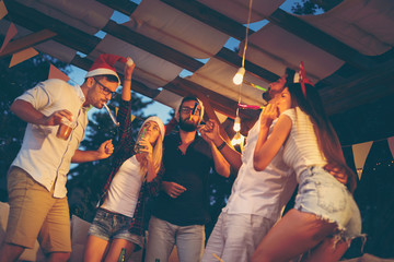 Blowing party whistles at New Year's Eve party