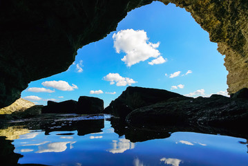 Sea cave in the rock overlooking the sea .