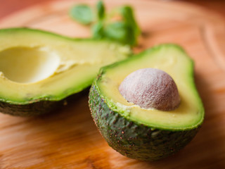 Avocado Halfs on wooden cutting board or table.