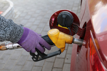 Fototapeta premium Hand holding a gasoline feed gun