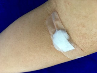 Plaster and cotton patch on the arm after the blood test.