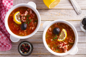 Traditional Russian dish  solyanka - thick, spicy and sour saltwort soup.  View from above, top studio shot