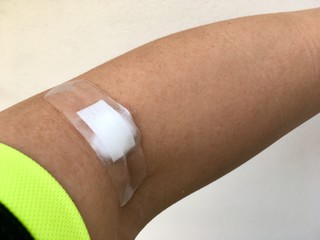 Plaster and cotton patch on the arm after the blood test.